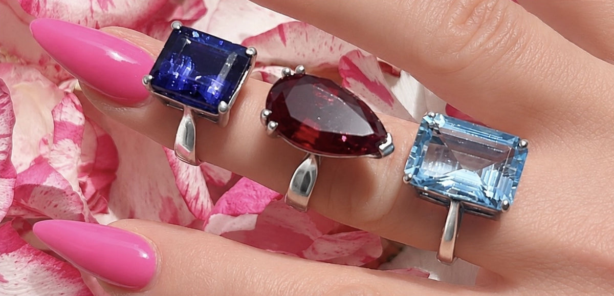 Three statement rings from The Bardot Collection worn together on pink petals